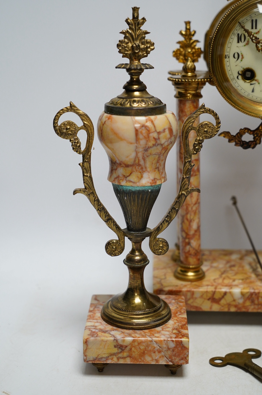 An early 20th century century French marble clock garniture, key and pendulum, 40cm. Condition - fair to good